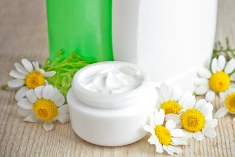 Cosmetics and chamomiles Stock Photos