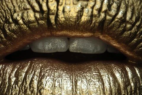 Cosmetics and make-up. Macro close up gold lips lipstick and gloss. Sexy and Stock Photos