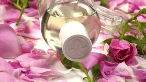 Cosmetics based on roses, bottles with perfumes  are on a white table, side view Stock-Footage 337404048