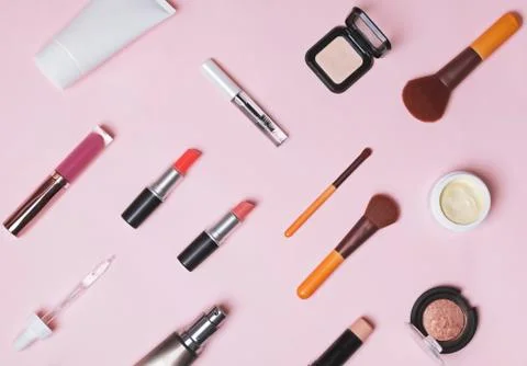 Cosmetics, brushes and make-up produts on the pink backgound Stock Photos