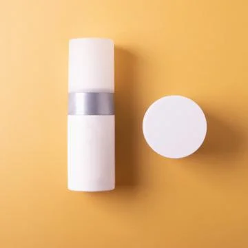 Cosmetics containers on yellow Foto stock