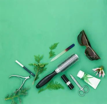 Cosmetics items on a light green background. Stock Photos
