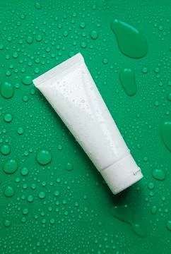 Cosmetics with moisturizing on a wet background. Selective focus. Stock Photos
