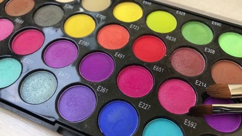 Cosmetics product authentic, make-up, bright multi-colored eye shadow set, brush Stock Footage 76638019