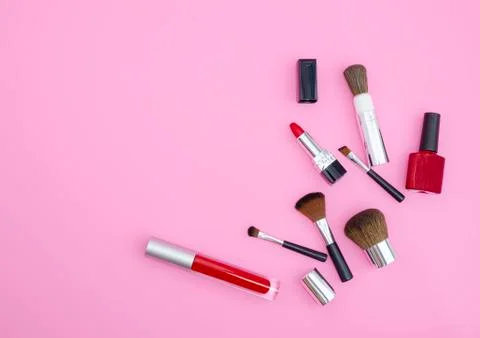 Cosmetics products red color on pink background. Stock Photos