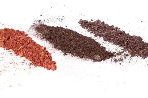 Cosmetics. Scattered multicolored eye shadow isolated on a white background Stock Photos