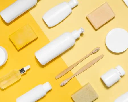 Cosmetics for skin and face pattern on yellow background Stock Photos