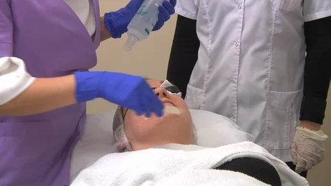 A cosmetologist applying a facemask Stock Footage 111497886