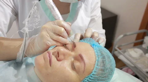 Cosmetologist applying permanent make up on eyebrows- eyebrow tattoo Stock Footage 63849705
