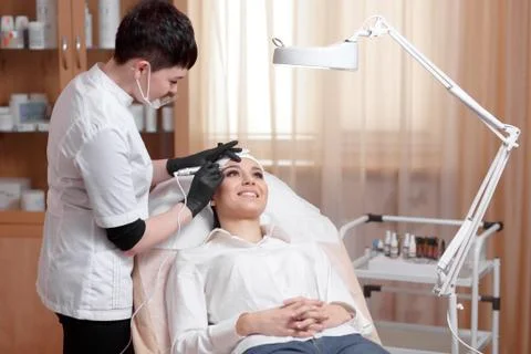 Cosmetologist applying permanent make up on eyebrows- eyebrow tattoo Stock Photos