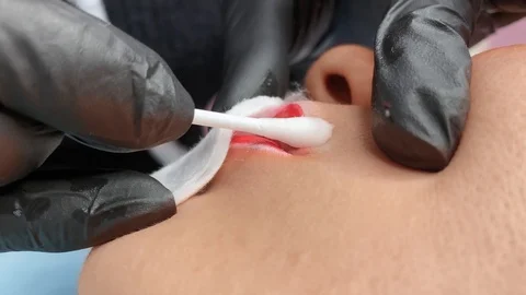 Cosmetologist applying permanent makeup on lips. Cosmetology procedure. Applying Video stock 119892192