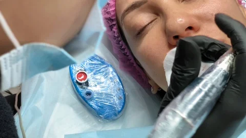 Cosmetologist applying permanent makeup on lips. Cosmetology procedure. Applying 스톡 동영상 119892352