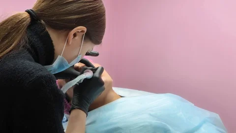 Cosmetologist applying permanent makeup on lips. Cosmetology procedure. Applying Stock Footage 119892492