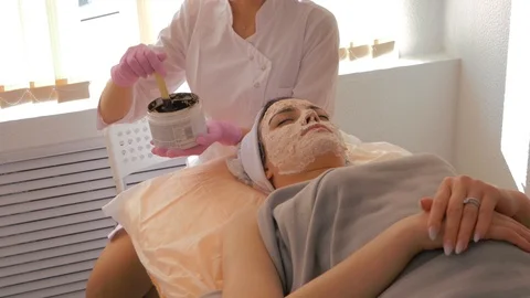 Cosmetologist is blending mask before applying it on the patient's face. Stock Footage 118920849