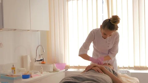 Cosmetologist is cleaning the clients face. Video stock 118920599