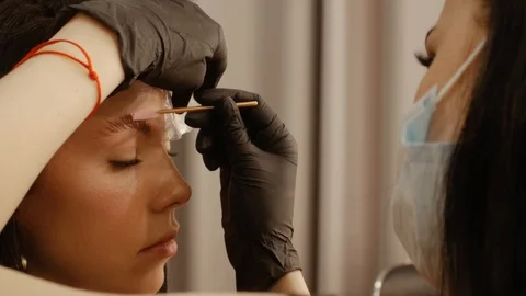 Cosmetologist is combing the eyebrows Stock Footage 108002074
