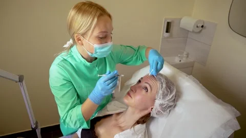 Cosmetologist doctor making multiple injections biorevitalization with Video stock 254357341
