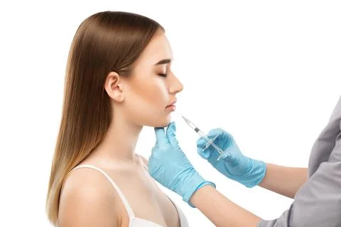 Cosmetologist does injections for lips augmentation and anti wrinkle in the.. Stock Photos