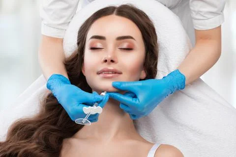Cosmetologist does injections for lips augmentation and anti wrinkle in the.. Stock Photos