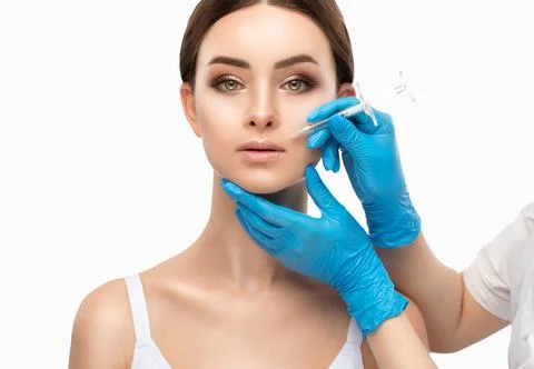 Cosmetologist does injections for lips augmentation and anti wrinkle in the.. Stock Photos