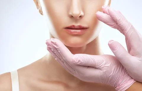 Cosmetologist does injections for lips augmentation anti wrinkle injections.. Stock Photos