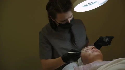 Cosmetologist does procedures for the client, facial care Stock Footage 219957826