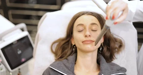 Cosmetologist doing laser facelifting procedure in beauty clinic Stock Footage 149328275