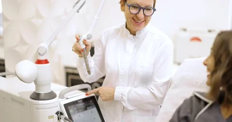 Cosmetologist doing laser facelifting procedure in beauty clinic Stock Footage 149328380