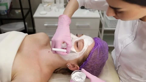 Cosmetologist doing procedures for a client's face in a spa or salon. Stock Footage 219379818