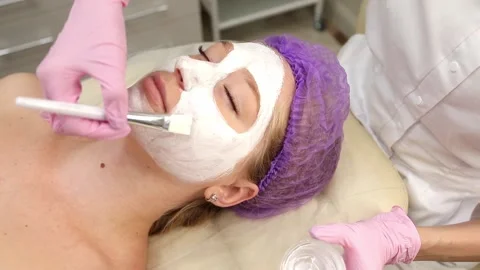 Cosmetologist doing procedures for a client's face in a spa or salon. Stock Footage 219379841
