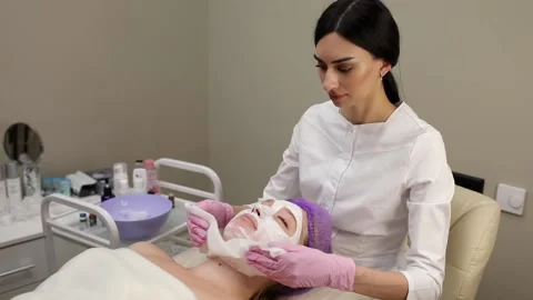 Cosmetologist doing procedures for a client's face in a spa or salon. Stock Footage 219379847