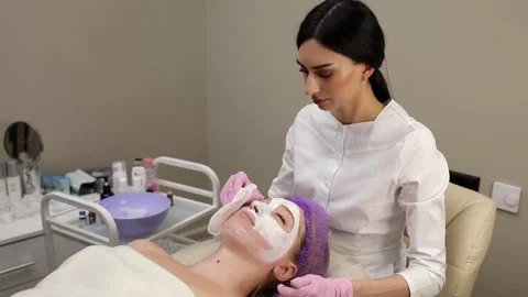 Cosmetologist doing procedures for a client's face in a spa or salon. Stock Footage 219379848