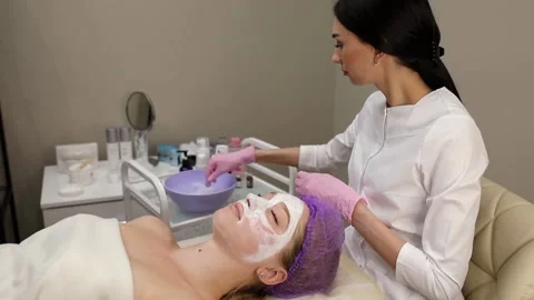 Cosmetologist doing procedures for a client's face in a spa or salon. Stock Footage 219379855
