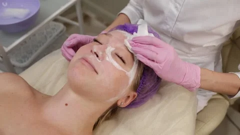Cosmetologist doing procedures for a client's face in a spa or salon. Stock Footage 219379871