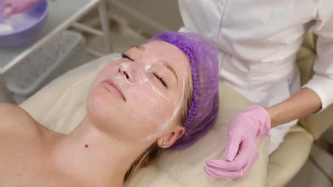 Cosmetologist doing procedures for a client's face in a spa or salon. Stock Footage 219379880