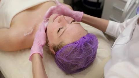 Cosmetologist doing procedures for a client's face in a spa or salon. Stock Footage 219379884