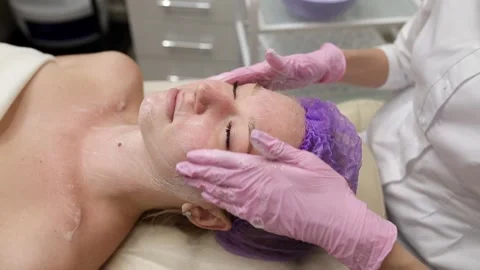 Cosmetologist doing procedures for a client's face in a spa or salon. Stock Footage 219799035