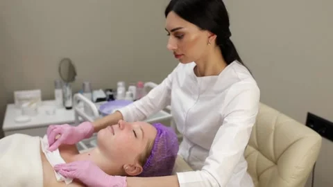 Cosmetologist doing procedures for a client's face in a spa or salon. Stock Footage 219799061