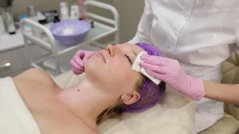 Cosmetologist doing procedures for a client's face in a spa or salon. Stock Footage 219799099