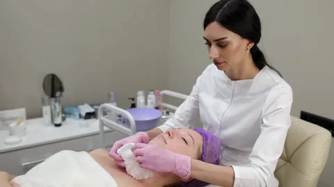 Cosmetologist doing procedures for a client's face in a spa or salon. Stock Footage 219799115