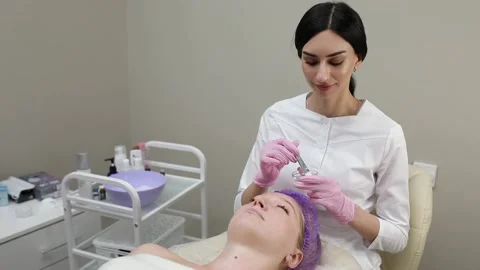 Cosmetologist doing procedures for a client's face in a spa or salon. Stock Footage 219799122
