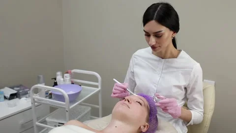 Cosmetologist doing procedures for a client's face in a spa or salon. Stock Footage 219799134