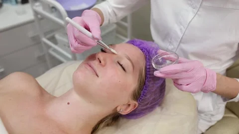 Cosmetologist doing procedures for a client's face in a spa or salon. Stock Footage 219799153
