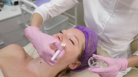 Cosmetologist doing procedures for a client's face in a spa or salon. Stock Footage 219799159