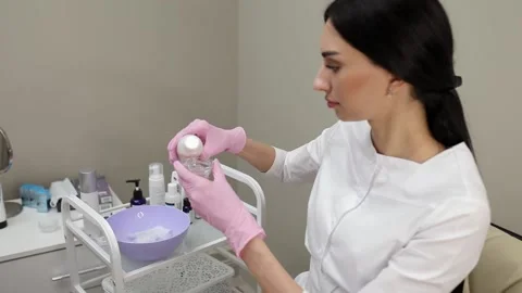 Cosmetologist doing procedures for a client's face in a spa or salon. Stock Footage 219799171