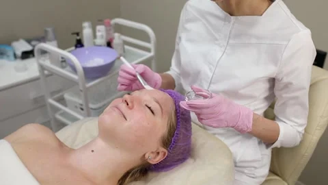 Cosmetologist doing procedures for a client's face in a spa or salon. Stock Footage 219799181