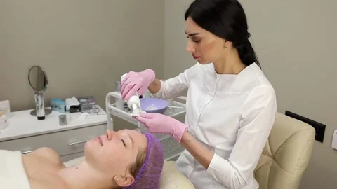 Cosmetologist doing procedures for a client's face in a spa or salon. Stock Footage 219799192