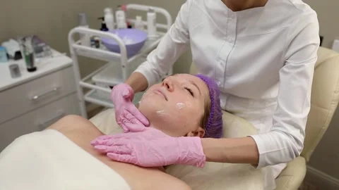 Cosmetologist doing procedures for a client's face in a spa or salon. Stock Footage 219799225