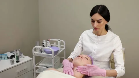 Cosmetologist doing procedures for a client's face in a spa or salon. Stock Footage 219799236