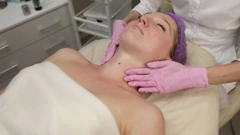Cosmetologist doing procedures for a client's face in a spa or salon. Stock Footage 219799241